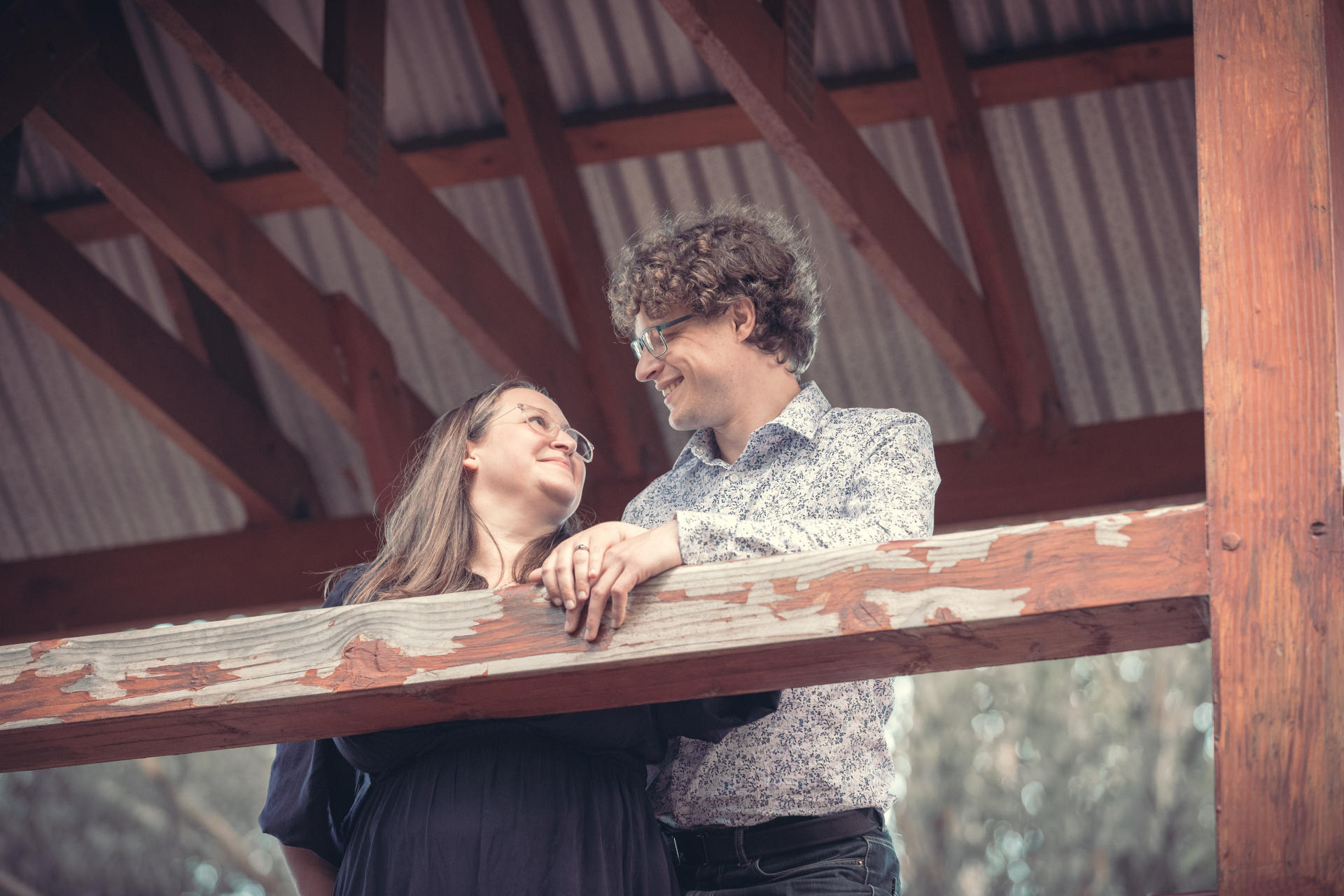 Libby & Tim on a bridge, sharing a moment.